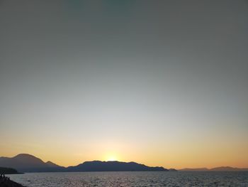 Scenic view of sea against clear sky during sunset