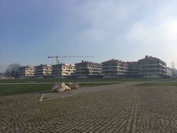 Buildings against cloudy sky