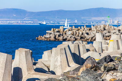 Panoramic view of sea and mountains against clear blue sky