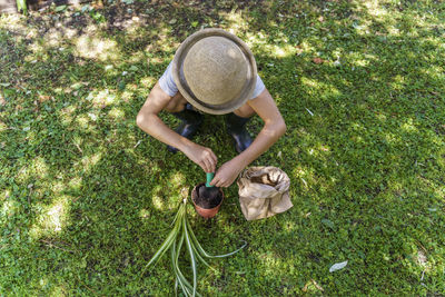 High angle view of man holding hat