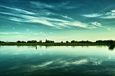 Scenic view of calm lake against blue sky