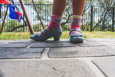 Low section of girl standing on porch