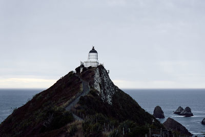 View of lighthouse against calm blue sea