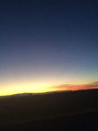 Scenic view of silhouette landscape against clear sky at sunset