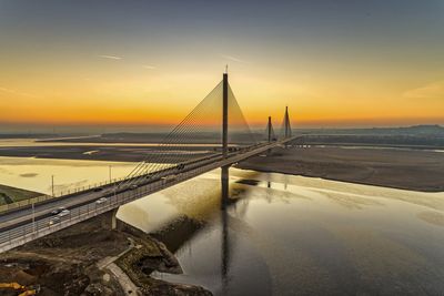 View of bridge over sea during sunset