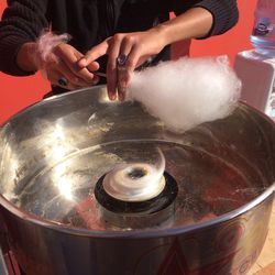 Midsection of man preparing cotton candy