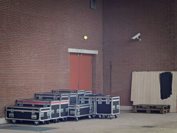 Stack of theatre cases against wall and a surveillance camera