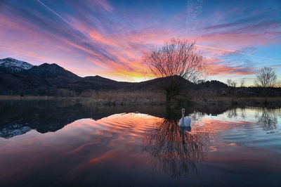 Scenic view of lake against sky during sunset