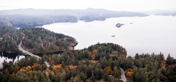 Scenic view of trees and mountains against sky