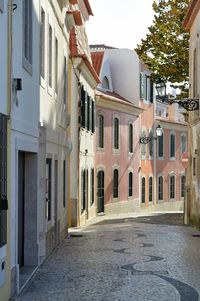 Empty alley amidst buildings in city