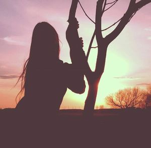 Silhouette of woman at sunset