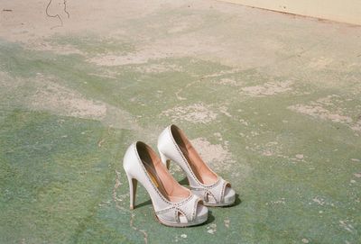 High angle view of shoes standing on grass