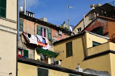 Low angle view of clothes drying on balcony against sky