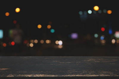 Defocused image of illuminated city at night
