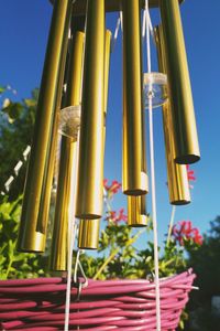 Low angle view of yellow bell against blue sky