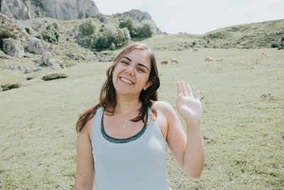 Portrait of young woman standing on mountain