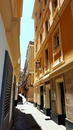 Street amidst buildings against sky