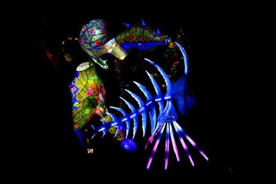 Close-up of illuminated blue light painting against black background