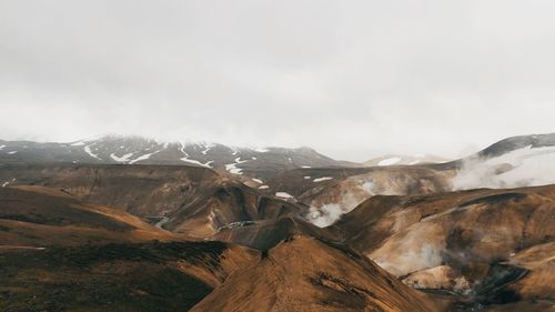 Scenic view of steamy mountain range kerlingafjöll in iceland against sky