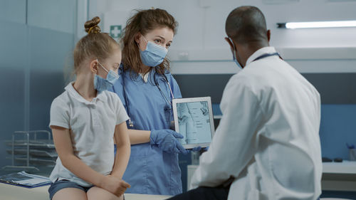 Female doctor examining patient in hospital