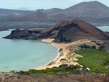 Scenic view of beach and mountains at sullivan bay, bartolome, galapagos islands