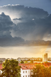 Buildings against cloudy sky