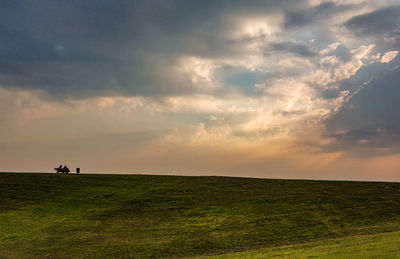 Scenic view of field against sky during sunset