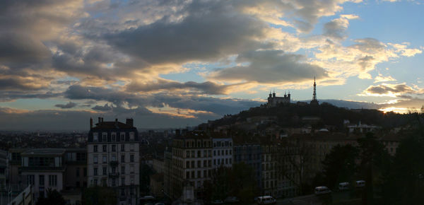 High angle view of buildings in city at sunset