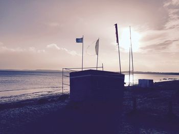 Lifeguard hut on beach against sky