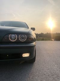 Vintage car on road against sky during sunset