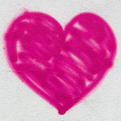 Close-up of pink heart shape drawn on wall