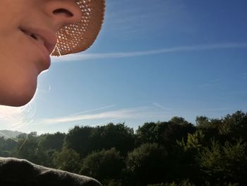 Close-up of boy against clear sky
