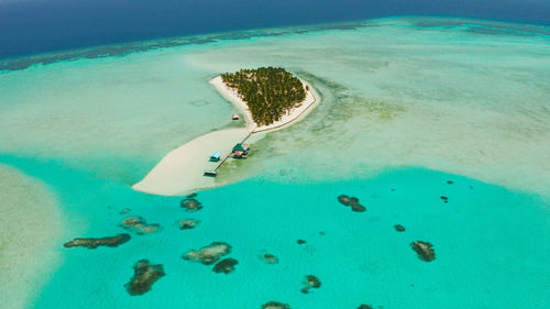 Seascape with beautiful beach and tropical island surrounded by a coral reef. onok island, balabac