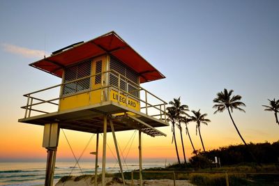 Low angle view of lifeguard hut at sunset