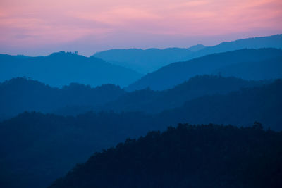 Scenic view of silhouette mountains against sky during sunset