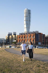 Couple walking, turning torso on background, malmo, sweden