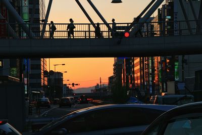 People in city at sunset