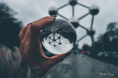 Close-up of hand holding glass of street