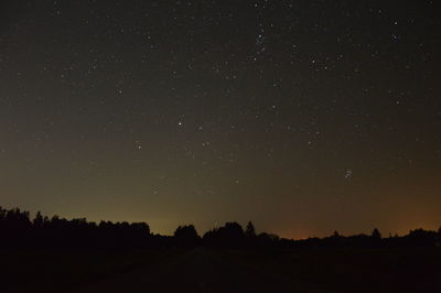 Scenic view of silhouette trees against sky at night