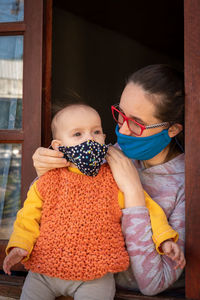 Mother teaching her baby to wear a chinstrap