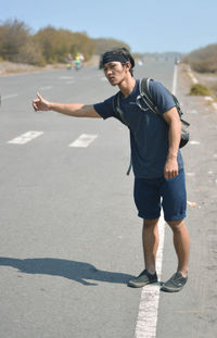 Full length of young man standing on road