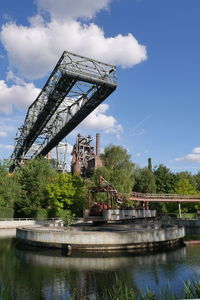 Low angle view of crane and blast furniert against sky in duisburg 