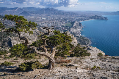 High angle view of rocks by sea against mountains