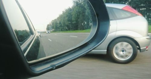 Cropped image of car on road