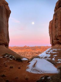 Rock formations on landscape against sky during winter