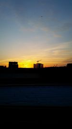 Built structure against sky at sunset