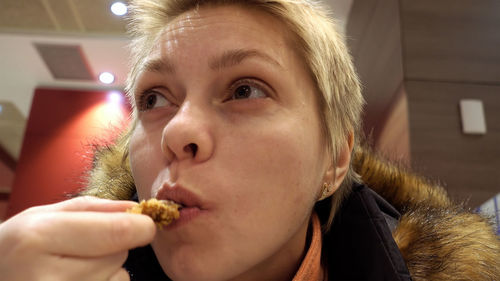 Close-up of boy eating food at home