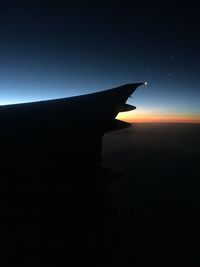 Close-up of silhouette landscape against sky at sunset