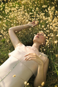 Woman lying among harestail grass