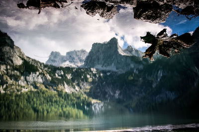 Scenic view of mountains against cloudy sky